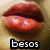 Pixelated close-up of lips with glossy red texture and two white highlights, set against a muted brown background with the word 'besos' in black and white pixelated text below.
