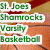 Green pixelated text reads 'St. Joe's Shamrocks Varsity Basketball' on white rectangular backgrounds against a brown and red blurred backdrop.