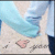 Pixelated beach scene with light blue water, sandy shore, and a pink heart shape on the sand.