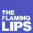 Pixelated animated contact sheet featuring orange blob-like creatures with eyes and spiky protrusions against a blue background, repeated text "THE FLAMING LIPS" in white block letters, and a lower section of blue-and-white pixel noise.