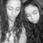 Black-and-white pixelated image of two people with long hair, accompanied by pixelated text on a black background.