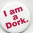 A circular icon with a white background displays red pixelated text reading "I am a Dork." in a casual handwritten style.