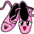 Pixelated pink ballet shoes with black interiors, each featuring a face with large eyes and red mouths, tied with purple ribbons.