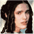 Pixelated static image of a person with long dark hair, light skin, and a neutral expression, wearing a light blue top against a light gray background.