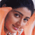 Pixelated static image of two people in close proximity with orange background and dark hair, likely a low-resolution buddy icon from early 2000s instant messaging platforms.