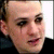 A pixelated image with a person's face on the left, purple and black text blocks reading 'BENJ' and 'RIOT GIRL', and gray background sections.
