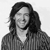 Black-and-white pixelated image of a person with long dark hair wearing a striped shirt, face partially obscured by pixelation.