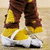 A person in brown and yellow pants and white shoes stands on a light brown floor with text overlay.