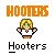 Pixel art animation of a blonde character with green eyes in white shirt and orange pants, surrounded by red/blue figures holding white orbs.