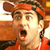 Pixelated static image of a person with red headwear and orange clothing against an indistinct background, likely from a movie or TV show character.