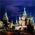 Pixelated image of a light-colored, ornate structure with multiple spires against a dark blue background, featuring brown and green accents.