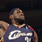 A basketball player in a dark blue jersey with white script text and red trim, wearing a headband, captured across showing subtle pose shifts