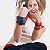 Animated contact sheet showing two frames of a woman in casual clothing with red and blue accents, transitioning from covering her face to revealing an embrace pose against a plain background.