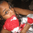 A pixelated image of a person with light brown hair wearing a red and white outfit, lying down with one arm extended.