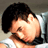 Pixelated static image of a person with dark hair and light skin, partially obscured by motion blur or pixelation effects.