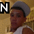 A pixelated image of a person wearing a gray cap and white sleeveless shirt, with visible text characters 'N', 'i', 'C', 'k' in black and white.