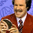 A pixelated image of a man in a red sweater holding a woman, with text reading "ANCHORMAN THE LEGEND OF RON BURGUNDY" on the right side against a blue background.