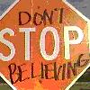 A diamond-shaped orange sign with white border displays text: 'DON'T STOP BELIEVING' in mixed fonts.
