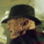 Static pixelated image of a character wearing a black bowler hat and dark clothing against a muted background with visible dithering and low-resolution artifacts.