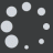 White circular dots of varying sizes scattered across a dark gray background with a light gray rectangular shape in the bottom right corner.