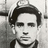 Black-and-white photograph of a person with dark hair and a cap, red text reading "My witness is the empty sky Jack Kerouac" on dark background.
