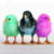 Three pixelated cartoon birds standing side-by-side on a flat surface with solid-colored bodies and simple facial features.