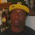 A person wearing a yellow cap and dark shirt appears in three with slight variations in background lighting and positioning