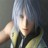 Pixelated static image of a person with light-colored hair and dark clothing, partially obscured by motion blur or compression artifacts.