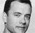 Black-and-white pixelated portrait of a person with short dark hair, closed eyes, and a neutral expression, cropped to show head and shoulders against a light background.