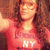 Pixelated image of a person with long brown hair wearing a red top with white text 'HY' visible on the chest.
