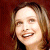 A static split-screen image shows a pixelated portrait on the left and green text on a dark background on the right.