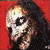 A pixelated image of a person with dark hair against a red background, transitioning to a stylized text graphic with red and blue elements.