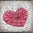 A red heart-shaped icon with striped patterns on a textured gray background, displayed in a