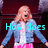 A pixelated image of a woman in a blue jacket and pink skirt with cyan text overlay reading "How does she hold her breath that long??!".