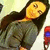 Pixelated image of a person with long dark hair lying down, wearing a dark green outfit, against a light background with a red and blue object on the right.