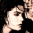 Pixelated static image of a person's face in profile view with visible facial features and partial shoulder, set against dark background.