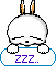 Pixelated white rabbit with orange-tipped ears rests on a cloud-shaped sign reading ZZZ.. in purple text, eyes closed and mouth open.