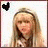 Two side-by-side pixelated images of a person with long blonde hair wearing a headband, each featuring a black heart symbol in the top-left corner.