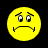 Static pixelated yellow smiley face icon with downturned mouth, raised eyebrows, and squinting eyes on black background.