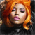 Pixelated close-up of a person with long orange hair, pink eyeshadow, and purple lips against a dark background.