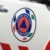 A pixelated circular icon with layered colors including red, blue, purple, and green within a gray border on a light background.