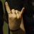 A hand making a rock-on gesture appears on the left, with 'ROCK ON!' text in red and white pixelated fonts across multiple