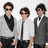 Three pixelated figures in formal attire stand side-by-side against a light background, each wearing sunglasses and distinct neckwear.