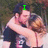 A pixelated image of two people embracing, with green text overlays changing across frames.