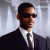 Static image of a person in dark suit and sunglasses against light background, with green text 'Original Icons .com' on right side.