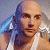A pixelated contact sheet showing two frames of an animated icon featuring a bald man with a towel over his shoulder on the left and green text reading "Original Icons .com" on the right against a dark background.