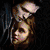 A pixelated image of a person holding a red apple with a heart-shaped bite, with 'twilight' text in blue on a dark background.