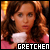 Pixelated image of a person with long brown hair wearing a white top and pink garment, set against warm-toned background with text "GRETCHEM" at bottom.