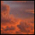 A static pixelated image with a gradient background transitioning from dark purple at the top to orange-red at the bottom, featuring indistinct shapes and no visible text or distinct subjects.
