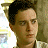 A 48x48 pixel buddy icon split into two frames showing a person on the left and green text on a dark background on the right, with visible pixelation and dithering effects.